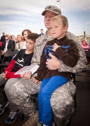 Sgt. Michael Ratai, 1st HBCT, 1st Infantry Division, observe the ribbon cutting ceremony and dedication of Seitz Elementary School, Sept. 14, 2012, Fort Riley, Kan.  Under Secretary of the Army Joseph W. Westphal provided remarks at the ceremony and reinforced the Army's commitment to education initiatives that promote national academic excellence.