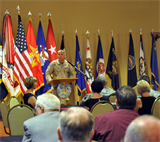 Colonel Michael Scalise, the commanding officer of Marine Corps Logistics Base Barstow, addresses the audience during the 23rd Annual Community Military Mixer at the Sandy Basin Community Center, Sept. 26. The military mixer provided new residents and employees the chance to socialize, network and relax in a friendly environment, while familiar faces strengthened their ties among service members and the High Desert community at large.