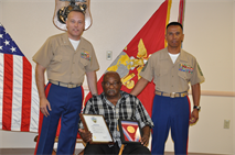 Col. Michael L. Scalise, commanding officer of Marine Corps Logistics Base Barstow, and 1st Sgt. Arthur Hernandez, pose with Montford Point Marine Staff Sgt. Haston Cox, as he holds his Congressional Gold Medal, Sept. 17, at the Maj. Gen. James L. Day Conference Center aboard the base. Cox honorably served in the United States Marine Corps from 1945-1965. Upon his retirement at Camp Pendleton, Cox moved to Barstow where he currently resides.