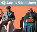 Photo of 2 people in chairs and the words Audio Slideshow