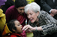 HHS Secretary Sebelius administers polio vaccine to a child in India. Credit: Photo by Rakesh Malhotra.