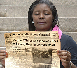 Oak Ridge National Laboratory graphic designer Ernestine Sloan looks at a 50-year-old newpaper from a critical time in the Clinton desegregation uproar. ORNL managing contractor UT-Battelle is supporting the Green-Macadoo Cultural Center Museum's effort to commemorate the watershed events.