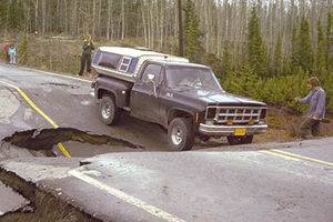 Photograph of truck attempting to cross a collapsed road.
