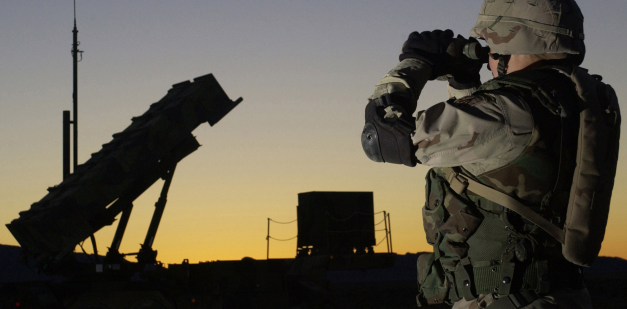 Soldier views a Patriot missile through binoculars 