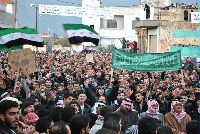 Date: 01/30/2012 Location: Homs province, Syria Description: Anti-Syrian regime protesters wave Syrian revolution flags and chant slogans during a demonstration against Syrian President Bashar Assad in the Deir Baghlaba area in Homs province, central Syria, on Friday, Jan. 27, 2012.  © AP Image/Bashar Assad