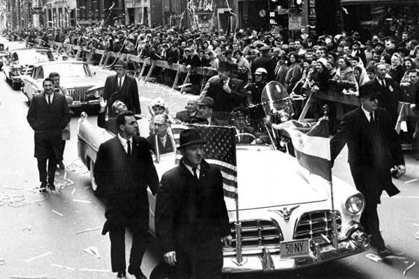 April 18, 1962: Office of Security Special Agent Frank Madden (front passenger seat) provides protection for the Shah of Iran, Mohammed Reza Pahlavi, and his wife Queen Farah Pahlavi (rear seat), during a New York City ticker tape parade. 