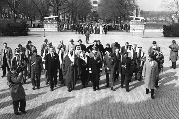 January 29, 1957:  Visit of His Majesty Saud al-Saud, King of Saudi Arabia, to the U.S. Naval Academy in Annapolis, Maryland.  Special Agents Joseph Rosetti (lower right corner, in overcoat) and James M. McDermott (second from right, in back row) provide the security detail. (Source: Private Collection)  