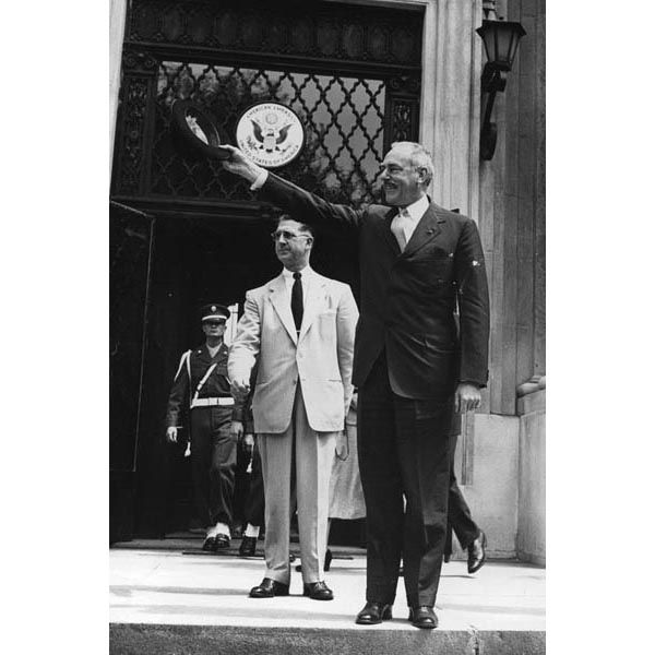 June 30, 1952:  Special Agent Frank Madden (center, white suit) looks on as U.S. Secretary of State Dean Acheson (waving hat) acknowledges well-wishers in front of the American Embassy in Vienna.  (Source: United States Information Service)