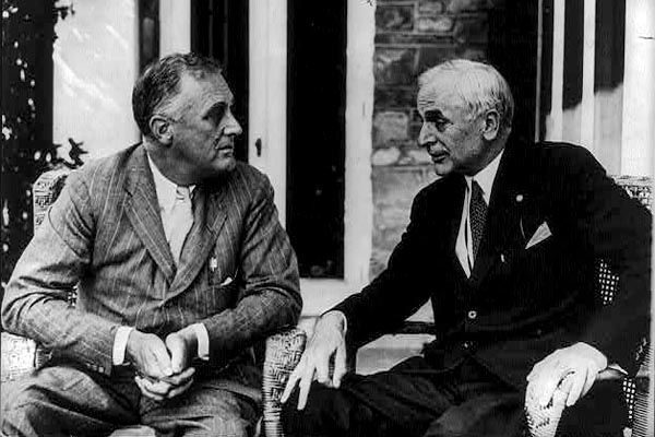 1941:  The day after the Japanese attack Pearl Harbor, U.S. Secretary of State Cordell Hull, shown here (right) with President Franklin D. Roosevelt, requests that he be assigned a protective detail by the State Department's Chief Special Agent.  This marks the first Secretary of State's protective detail. (Prints and Photographs Division, Library of Congress)