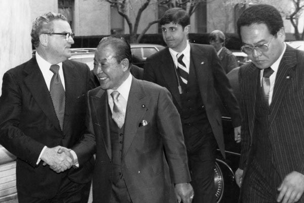 April 1979:  An SY special agent follows behind Foreign Minister Sunao Snoda of Japan in Washington, DC. (Source: DS Records)