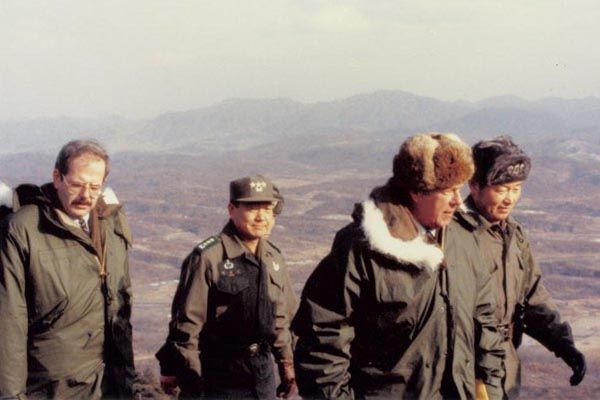 February 1983:  An SY special agent, left, covers Secretary of State George Shultz (second from right) along the Demilitarized Zone separating North and South Korea.  (Source:  Private Collection)