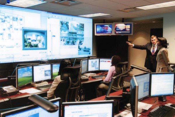 2005:  U.S. Secretary of State Condoleezza Rice is briefed by a DS special agent at the Diplomatic Security Command Center near Washington, DC. Critical law enforcement and security information is received, processed, and disseminated from the Command Center. (Source: DS Records)