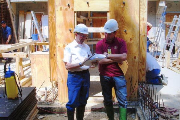 July 2006:  A security engineering officer (left) confers with a General Services officer at the construction site of a new U.S. Embassy Compound Access Control facility in Brussels, Belgium. (Source: Private Collection)