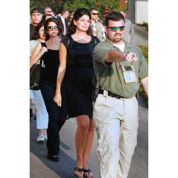 July 18, 2006:  A DS special agent guides American citizens toward the heliport within the grounds of U.S. Embassy Beirut in Lebanon for evacuation to Cyprus during the conflict between Israel and Hezbollah. More than 1,000 Americans are evacuated. (Source: Associated Press)