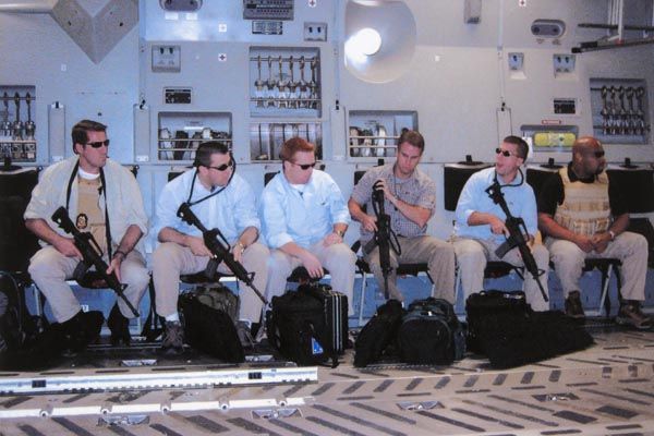 October 4, 2006:  DS special agents assigned to Secretary of State Condoleezza Rice's protective detail check their gear on board a C-131 that is about to land in Iraq.  (Source: U.S. Department of State)