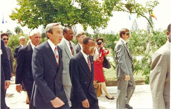 October 1994:  DS special agents (left and right of photo) surround U.S. Secretary of State Warren Christopher (left foreground) and Haitian President Jean-Bertrand Aristide (center in dark suit) during a visit to Haiti. U.S. Ambassador William Swing is immediately behind Sec. Christopher.  DS protected President Aristide after his return to power following a coup. (Source: Private Collection)