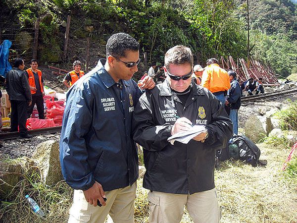 Two DS special agents from the U.S. Embassy in Lima assist Peruvian authorities in the evacuation January 29, 2010 of residents and tourists, including U.S. citizens, from the famed ancient Incan citadel of Machu Picchu after heavy rains, mudslides, and severe flooding hit the region. (U.S. Department of State Photo)