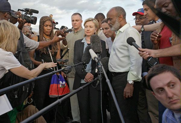 A Diplomatic Security special agent (left) watches the crowd as U.S. Secretary of State Hillary Clinton (2nd from left) and Haitian President Rene Preval (right) answer journalists' questions January 16, 2010, in Port-au-Prince, Haiti, about rescue and relief efforts in the aftermath of the January 12, 2010, earthquake that left tens of thousands of Haitians dead. (AP Photo)
