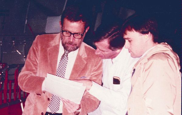 A DS special agent (right) joins in consultation with newly freed American hostage David Jacobsen (left), along with a State Department public affairs officer (center), aboard a flight to Washington, D.C., from Europe.  Jacobsen was kidnapped in May 1985 as he walked near the American University hospital campus in Beirut, Lebanon, and held captive for 17 months. (Source: Private Collection)