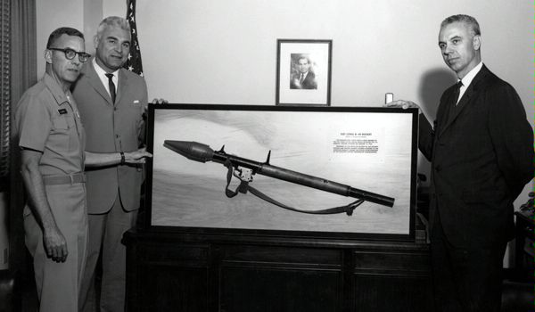 A captured Viet Cong B-40 rocket and launcher is presented to Office of Security (SY) Director Marvin Gentile (right) as a memento of the Tet Offensive attack on the U.S. Embassy in Saigon, South Vietnam, on January 31, 1968. 