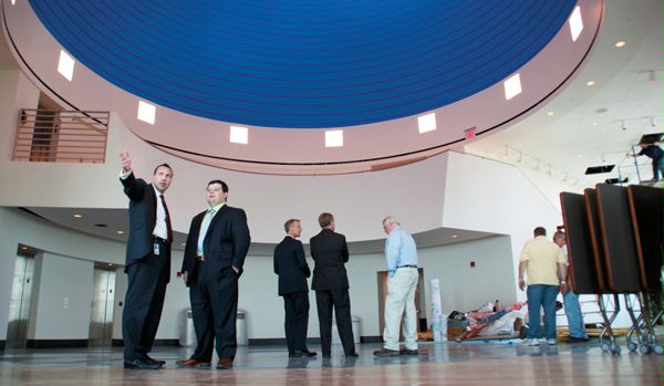 A DS assistant regional security officer (left) and special agent (second from left) admire finishing touches in the 22nd floor Diplomatic Reception area of the new U.S. Mission to the United Nations building, September 1, 2010. (U.S. Department of State photo)