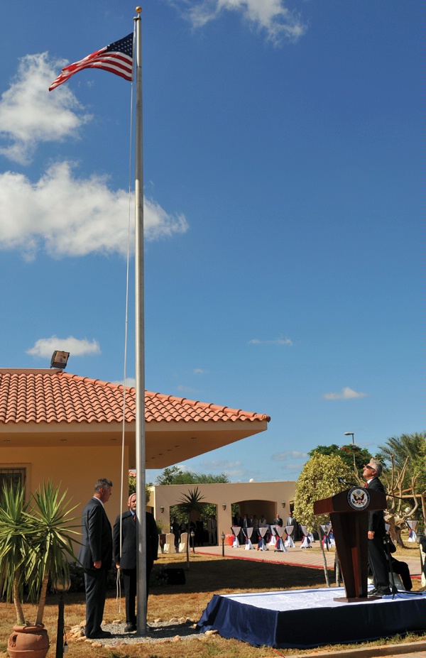 Two Diplomatic Security special agents raise the American flag  as U.S. Ambassador to Libya Gene Cretz (right) looks on at a  ceremony marking the September 22, 2011, re-opening of the U.S. Embassy in Tripoli, Libya one month after long-time Libyan leader Col. Muammar Qadhafi was forced to flee the capital. (U.S. State Department photo)
