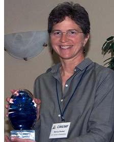 Photograph of Nancy holding her award.