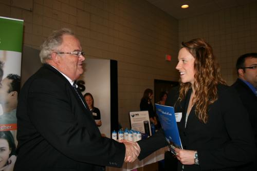 Billy speaks with Meghan Gleason, jobseeker and Drury University sophomore, at the Drury University Job Fair