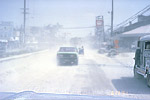 Ash stirred up by moving vehicles on city street, Philippines