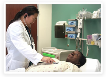 A doctor listens to her patient’s breathing