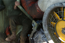 Sgt. Garrett Baresel, an Amphibious Assault Vehicle crewman, with 3rd Assault Amphibian Battalion, 1st Marine Division, works on his vehicle during a mock ship to shore operation aboard the USS Makin Island September 6. While Baresel is responsible for commanding his vehicle, he and his crew are also responsible for its maintenance.