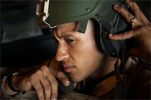 Lance Cpl. Henry Terriquez, an Amphibious Assault Vehicle crewman, with 3rd Assault Amphibian Battalion, 1st Marine Division, moniters the radio before commencing a mock ship to shore operation aboard the USS Makin Island September 6.