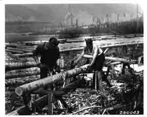 [graphic] Peeling logs for building at Camp F-20.