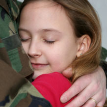 daughter hugging military father