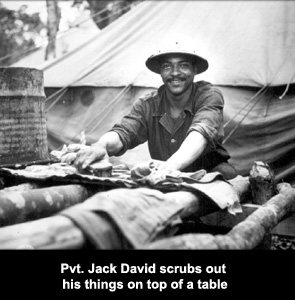 Private Jack David scrubs out his things on top of a table