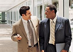 Photo of two people talking in the hall way