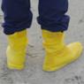 person stands on sand with foot protection