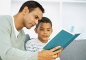 Father and son looking at a book