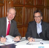 Bert van der Vaart, Executive Chairman of Small Enterprise Assistance Funds, left, and James Polan, OPIC Vice President for Small and Medium-sized Enterprise Finance During a January 26 Signing Ceremony