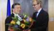 European Commission President Jose Manuel Barroso (L) receives flowers from Atle Leikvoll, Norway