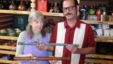 Donor Steven Martin and UI curator Priscilla Wegars hold antique opium pipes. (VOA/T. Banse)      