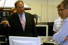 Deputy Secretary of Labor Seth Harris, left, speaks with Assistant Professor Sam Levenson, far right, about the importance of Harpers Advanced Manufacturing program. Photo Credit: Erin Brooks, Harper College. View the slideshow for more images and captions.