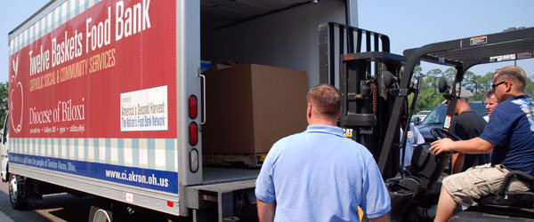 People loading up a food bank truck.