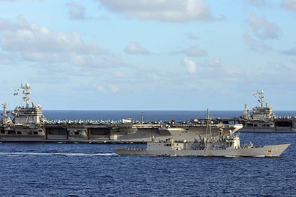 The Nimitz-class aircraft carriers USS George Washington (CVN 73) and USS John C. Stennis (CVN 74) and the guided-missile frigate USS Vandegrift (FFG 48) are underway in formation.  Ships and aircraft of the George Washington and John C. Stennis carrier strike groups are conducting exercises to increase interoperability, readiness, and the capability to respond quickly to various potential crises in the region, ranging from combat operations to humanitarian assistance. The U.S. Navy is constantly deployed to preserve peace, protect commerce, and deter aggression through forward presence. Join the conversation on social media using #warfighting.  U.S. Navy photo by Chief Mass Communication Specialist Jennifer A. Villalovos (Released)  121012-N-WW409-349