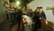 Palestinians wheel the body of a militant at a hospital, following an Israeli air strike in the northern Gaza Strip October 13, 2012.