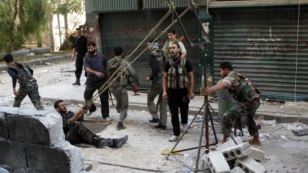 Members of the Free Syrian Army use a catapult to launch a homemade bomb during clashes with pro-government soldiers in the city of Aleppo, October 15, 2012. 