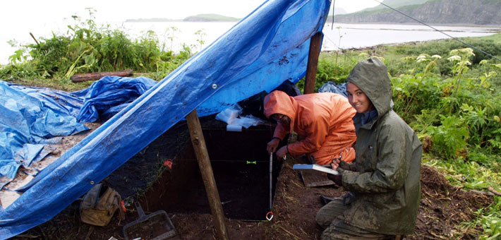 Photo of two people on a rainy day during an archeology dig at Aniakchak. Photo courtesy of Brian Hoffman.