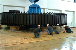 KUTTAWA, Ky. — A work crew with National Electric Coil from Columbus, Ohio secures a 270-ton rotor assembly onto a pedestal at the Barkley Dam Hydropower Plant here, Aug. 16, 2012. The U.S. Army Corps of Engineers Nashville District is rehabilitating a hydropower generator damaged in an electrical fire in January 2010.