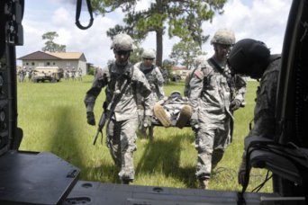 Army Reserve Soldiers of the 320th Military Police Company of St. Petersburg, Fla,, including Spc. Jared N. Whiteman of Holiday, Fla.,, left, and Pfc. Joel D. Birtel of Tampa, Fla., were taught to carry a "casualty" feet first during a joint Florida Army National Guard and Reserve medevac operation at Camp Blanding, Fla., July 20, 2012.