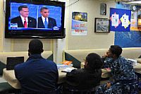 Sailors assigned to the Arleigh Burke-class guided-missile destroyer USS McCampbell (DDG 85) watch the first 2012 presidential debate.